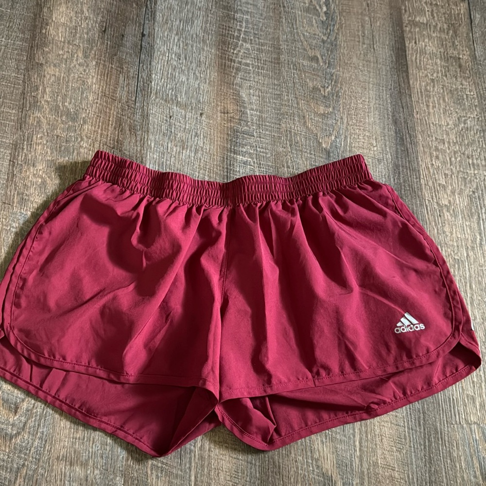 Maroon adidas shorts, 3” length